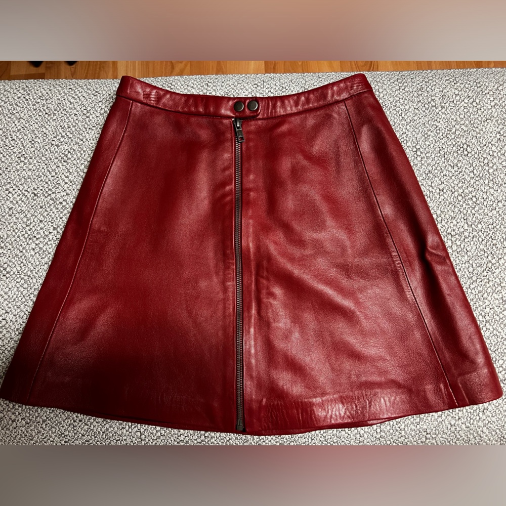 Never been worn Muubaa red leather mini skirt sz 2, with zipper and snap.